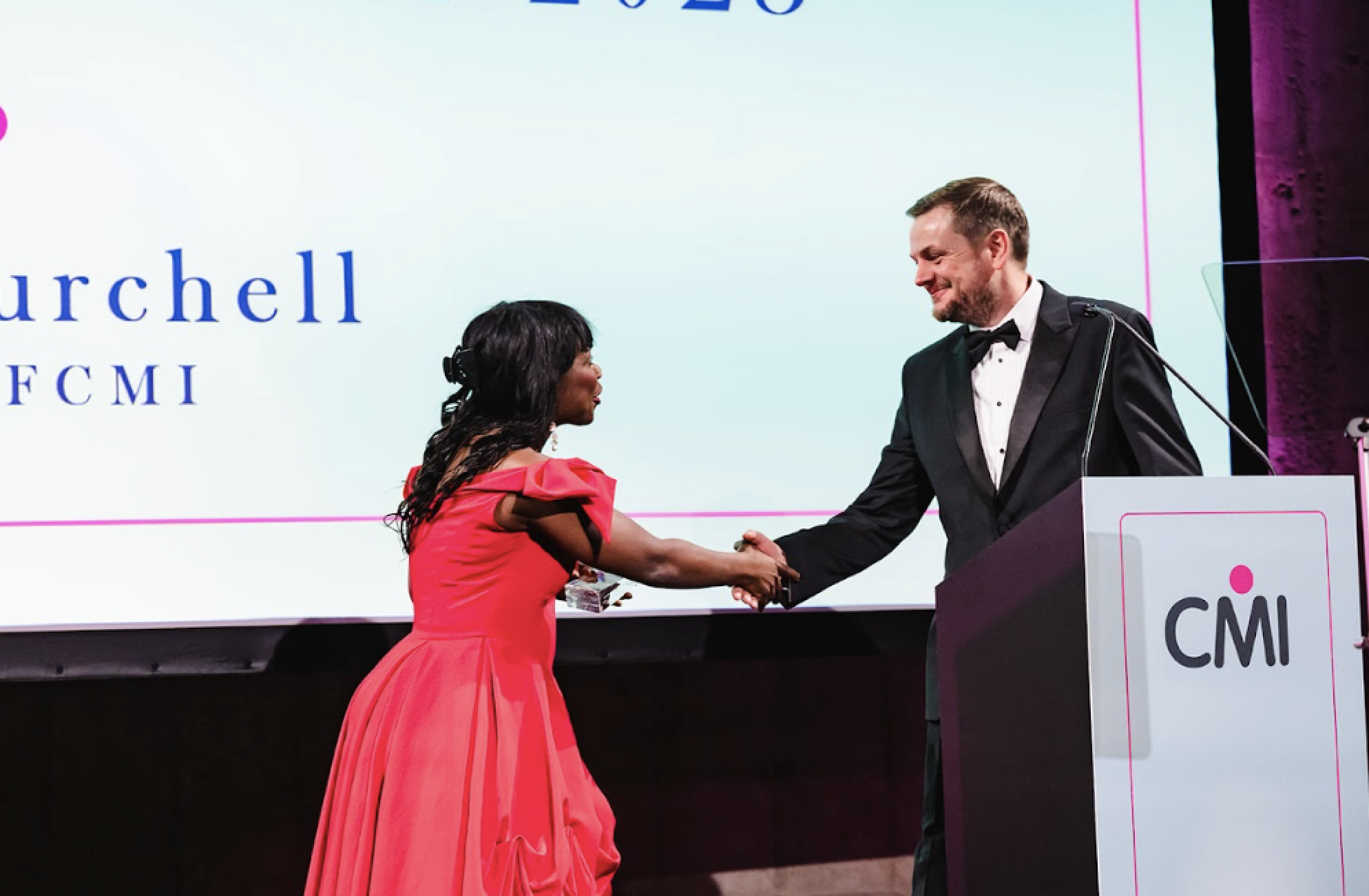 Two award winners shaking hands at last year's CMI President's Dinner