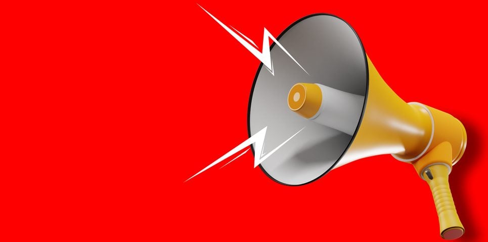 Megaphone with lightning on red background.