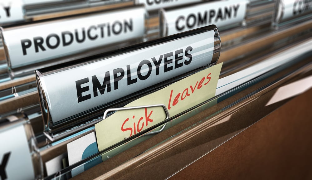 Close up on a file tab with the word employees plus a note with the text sick leaves, blur effect at the background. Concept image for illustration of sick leave entitlement