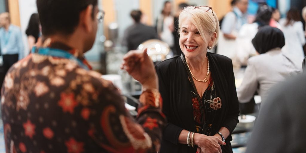 Ann Francke OBE CMgr CCMI talking to another attendee at an event