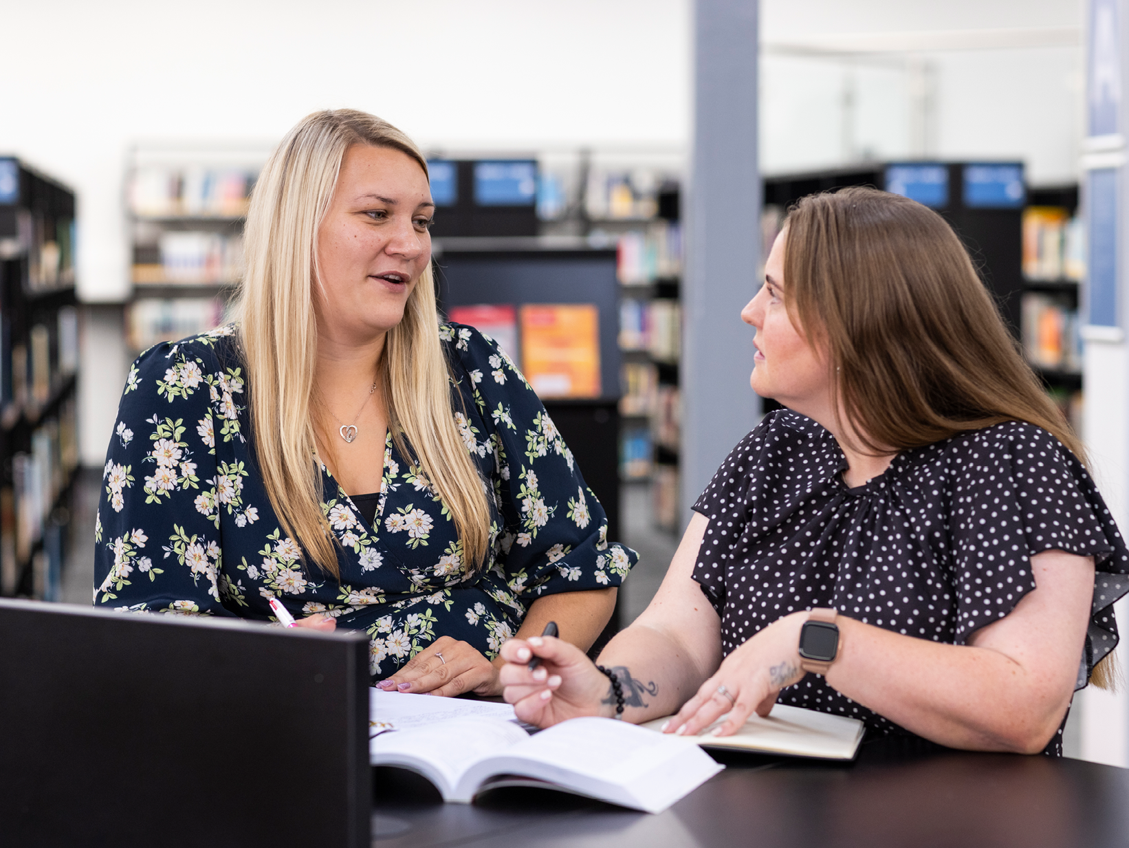 Two people in conversation at Staffordshire University