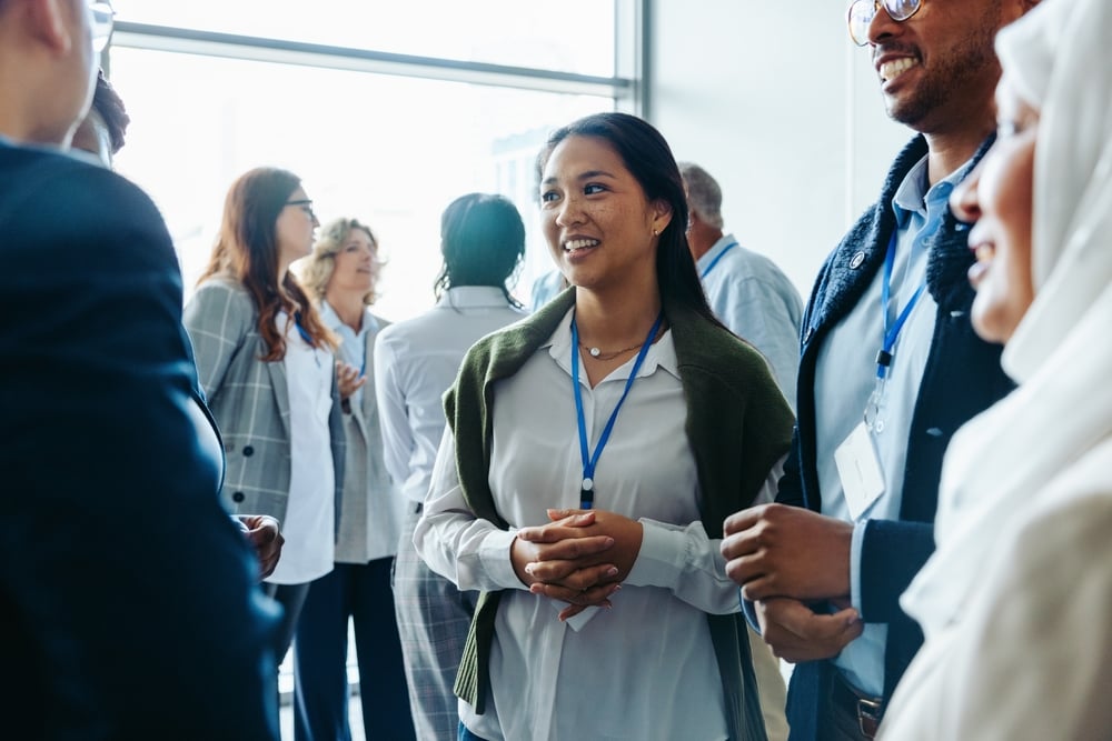 Group of diverse business professionals, businessmen and businesswomen, networking at a conference event